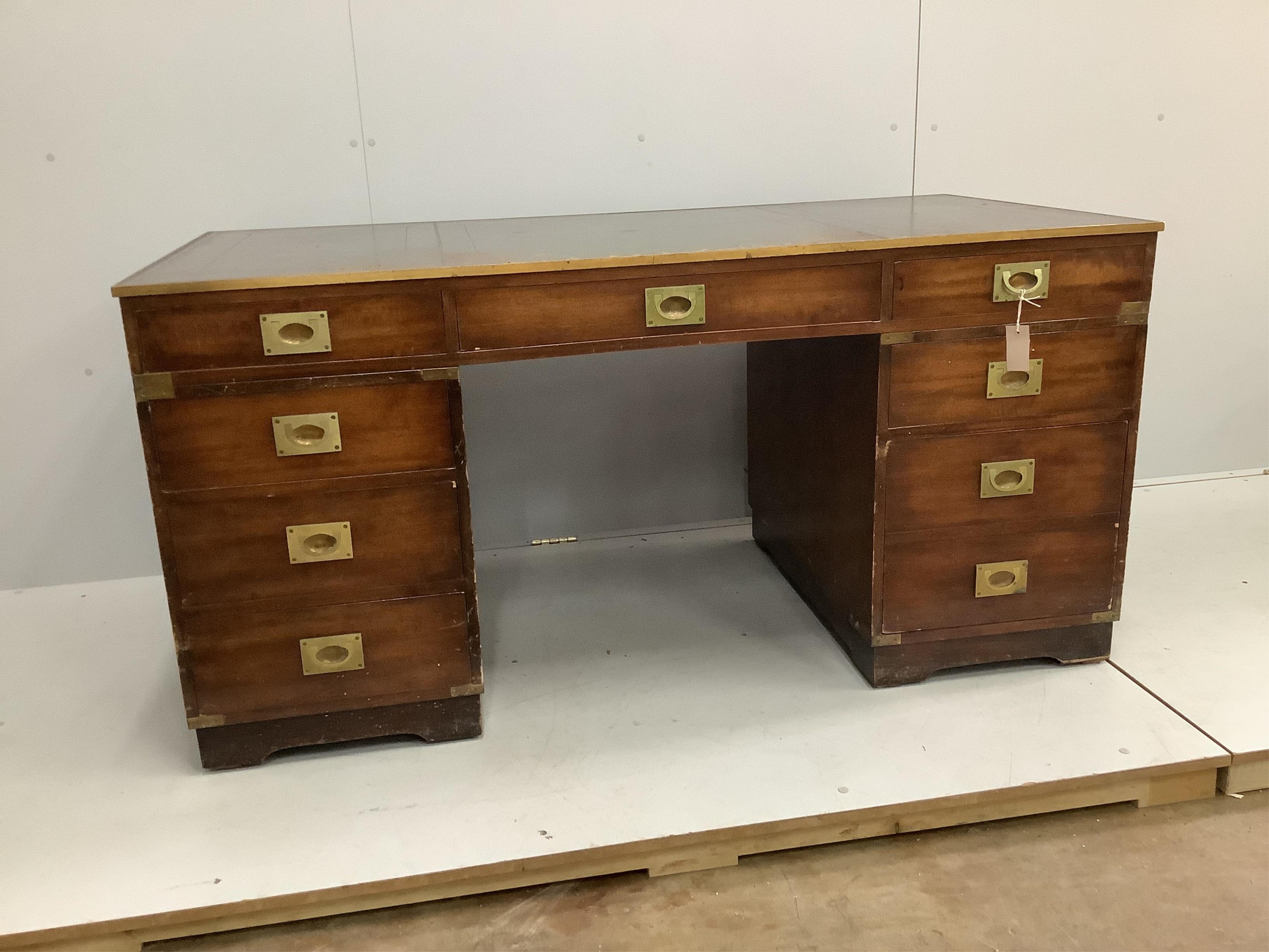 A mid century brass mounted military style mahogany twin pedestal desk, width 153cm, depth 77cm, height 75cm. Condition - fair